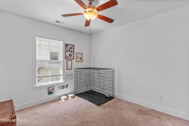 interior space featuring ceiling fan and light carpet