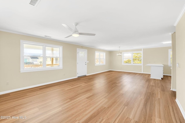 unfurnished living room featuring crown molding, ceiling fan with notable chandelier, and light wood-type flooring