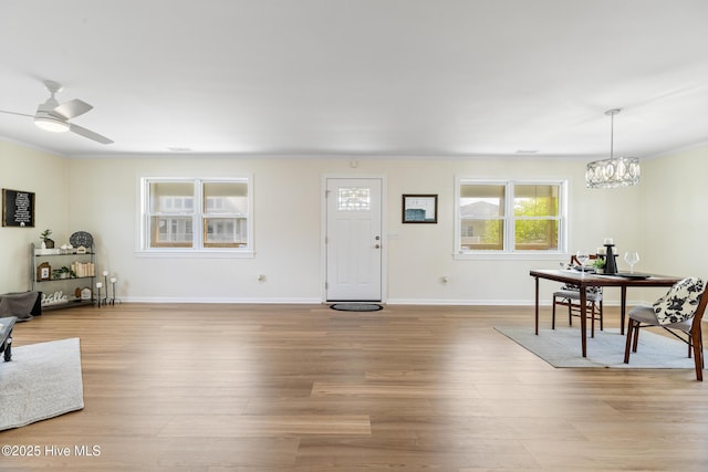 kitchen with tasteful backsplash, stainless steel fridge, a sink, a peninsula, and light wood finished floors