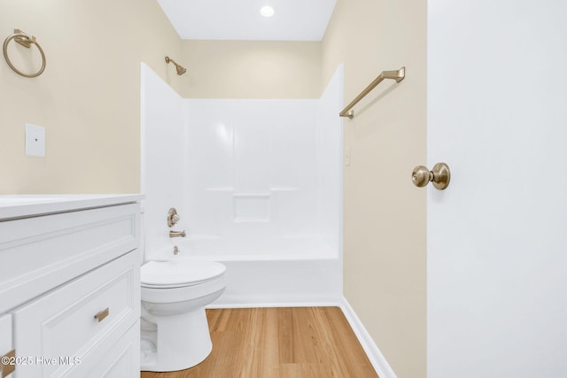 full bathroom featuring vanity, hardwood / wood-style floors, tub / shower combination, and toilet