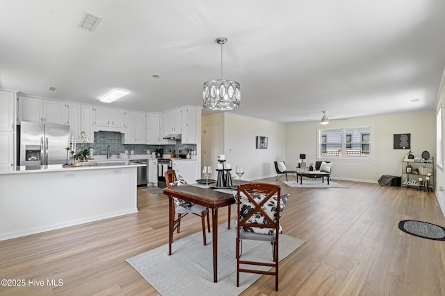 spare room featuring light wood-style flooring, baseboards, and visible vents