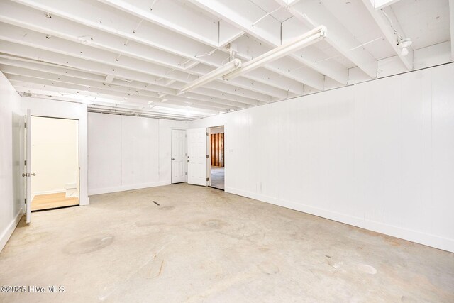 garage with a garage door opener and wood walls