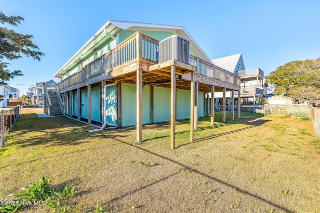 rear view of house with a yard and a deck