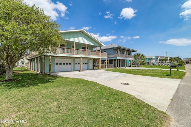 raised beach house with an attached garage, driveway, and a front lawn