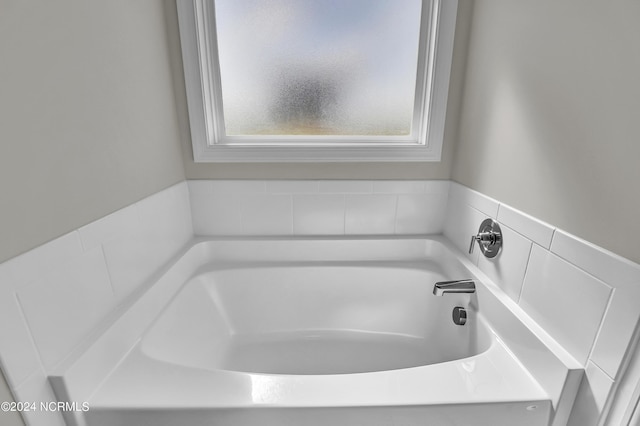 bathroom with a tub to relax in