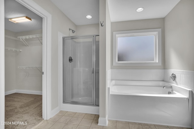 bathroom with tile patterned floors and plus walk in shower