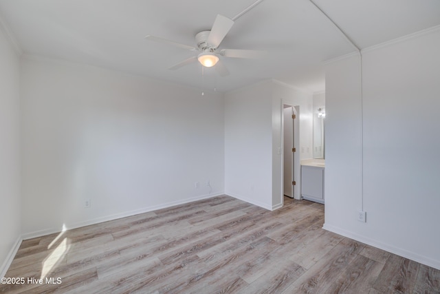 spare room featuring a ceiling fan, baseboards, ornamental molding, and light wood finished floors