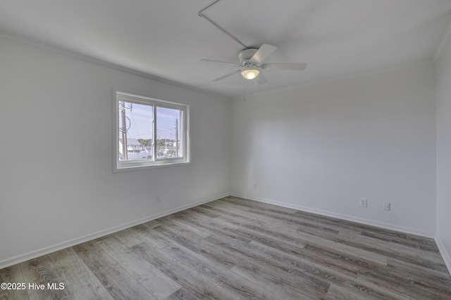 unfurnished room featuring crown molding, ceiling fan, baseboards, and wood finished floors