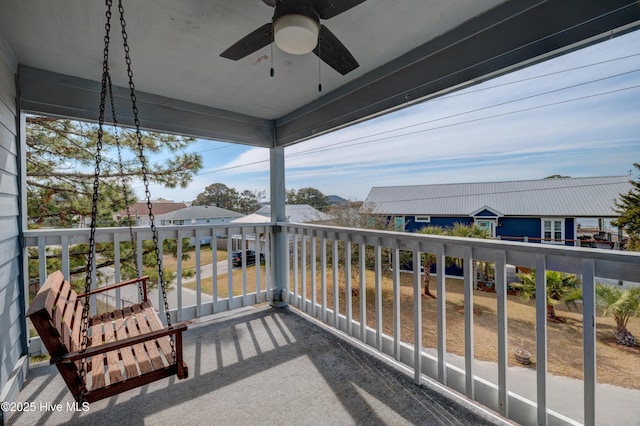 balcony featuring a ceiling fan and a residential view