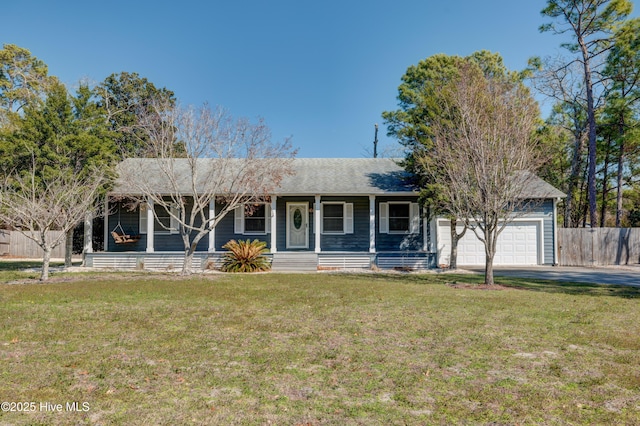 ranch-style house with an attached garage, fence, and a front yard