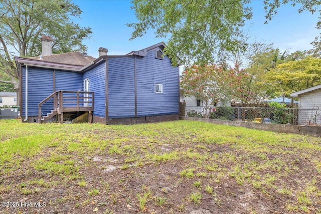 back of house with a yard and a deck