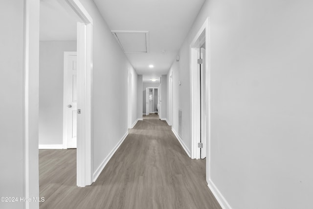 hallway with hardwood / wood-style floors