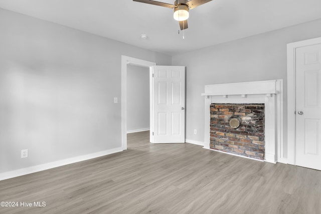 unfurnished living room featuring ceiling fan and light hardwood / wood-style flooring