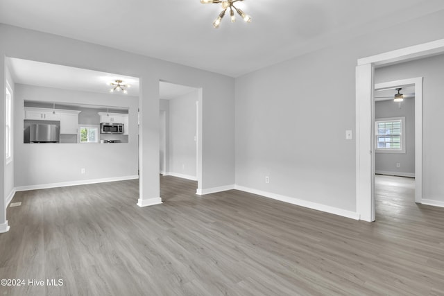 unfurnished living room featuring wood-type flooring and a wealth of natural light