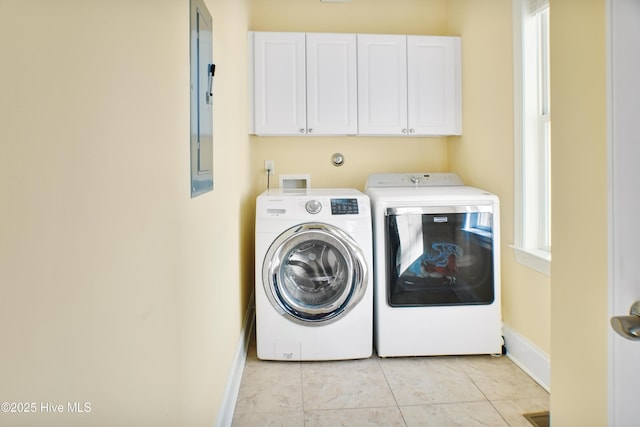 laundry room featuring plenty of natural light, light tile patterned floors, cabinets, and independent washer and dryer