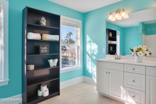 bathroom featuring vanity, a shower, tile patterned floors, and plenty of natural light