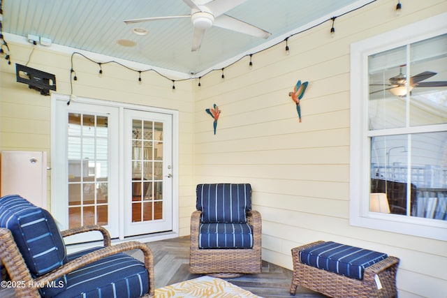 view of patio / terrace with a wooden deck, ceiling fan, and french doors