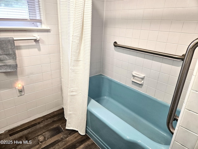 bathroom featuring wood-type flooring and shower / bath combo