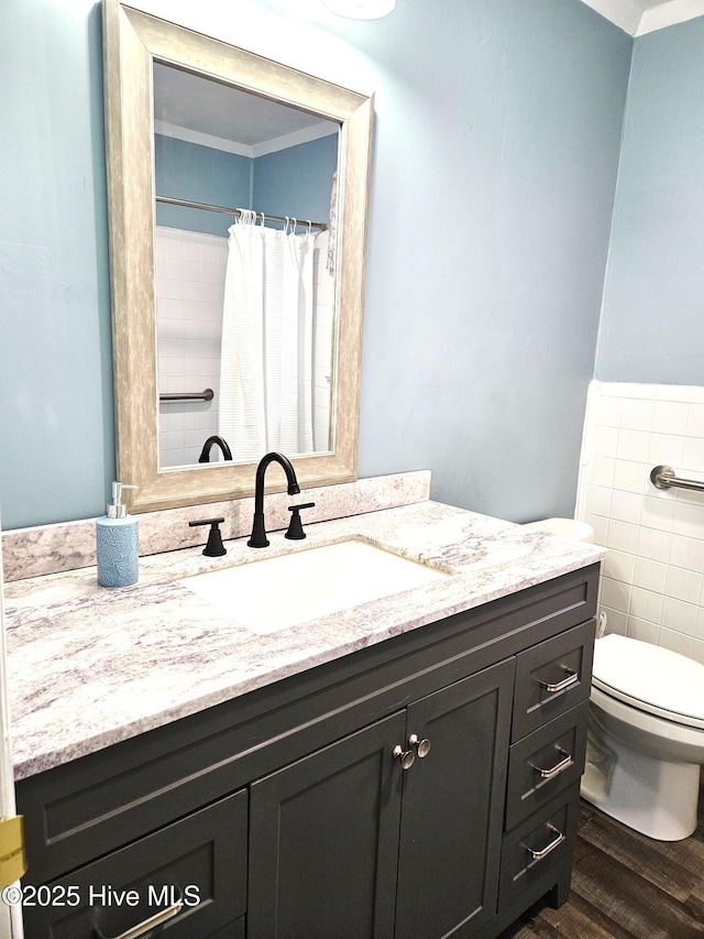 bathroom featuring hardwood / wood-style floors, toilet, and vanity