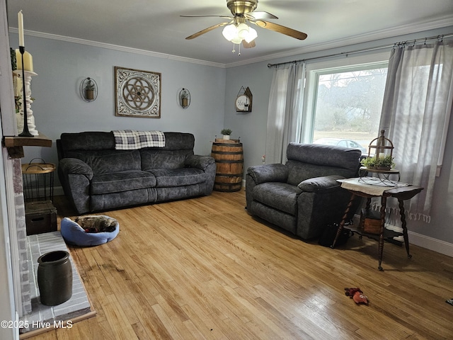 living room featuring wood-type flooring, ceiling fan, and ornamental molding