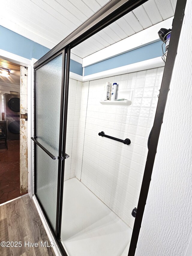 bathroom featuring hardwood / wood-style flooring and a shower with shower door