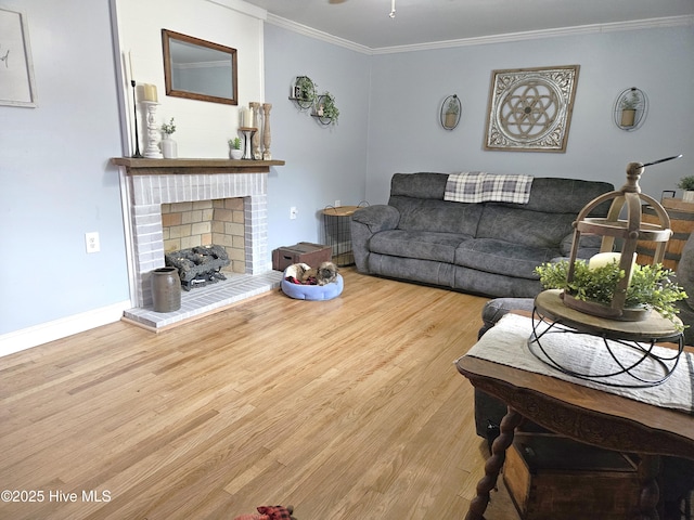 living room featuring a brick fireplace, crown molding, and light hardwood / wood-style floors