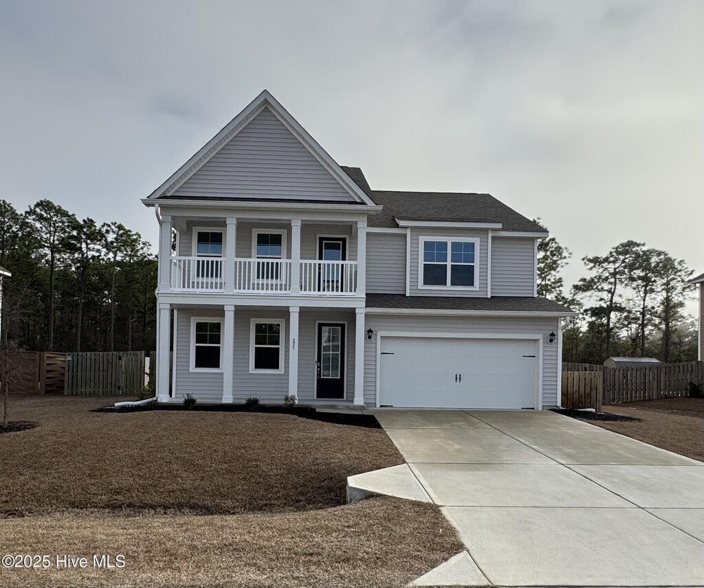 view of front of house featuring a garage and a balcony