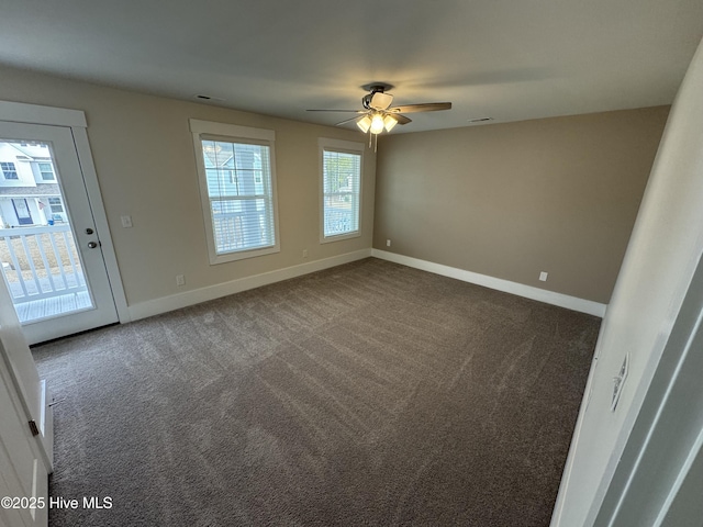 carpeted spare room featuring ceiling fan