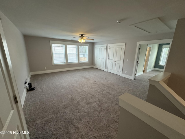 empty room featuring ceiling fan and light carpet