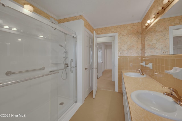 bathroom featuring crown molding, vanity, walk in shower, and tile walls