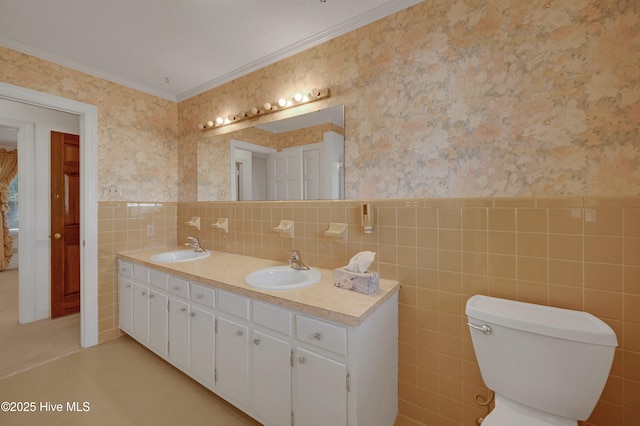 bathroom featuring tile walls, toilet, vanity, and crown molding