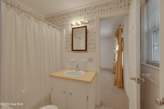 bathroom featuring a shower with curtain, ornamental molding, and vanity