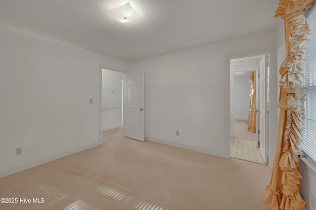 carpeted spare room featuring a textured ceiling