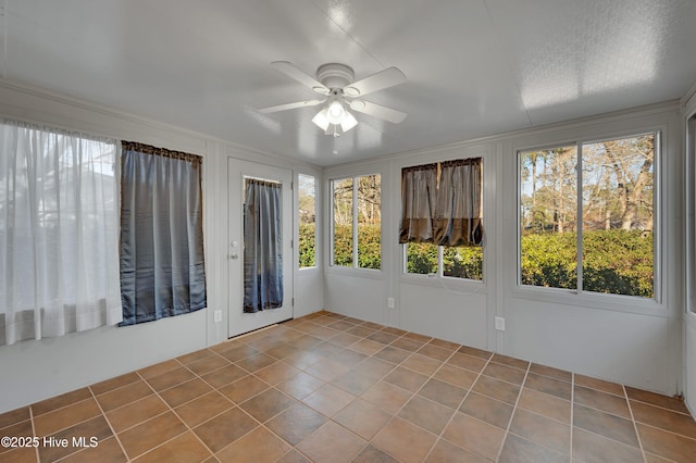 unfurnished sunroom with ceiling fan