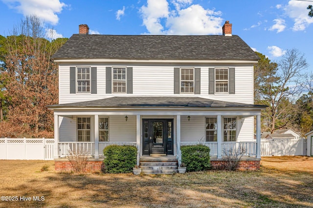 view of front of house with a porch and a front yard