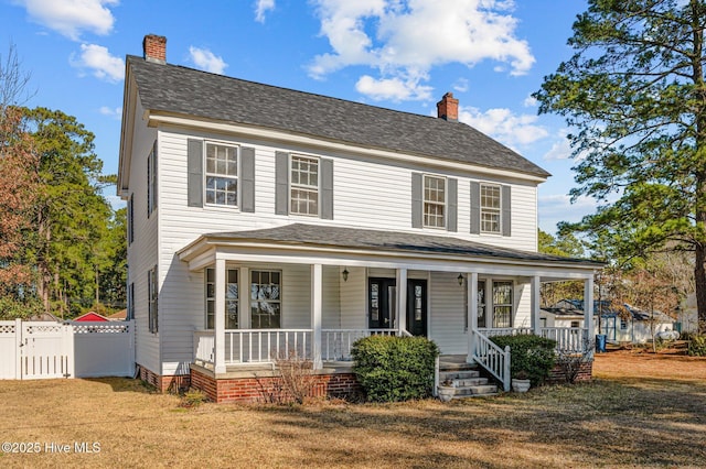 view of front of home with a porch and a front yard