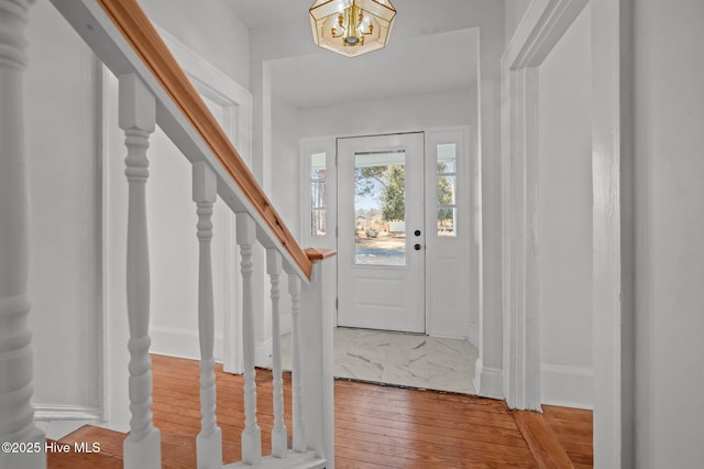 entryway featuring hardwood / wood-style floors and a notable chandelier