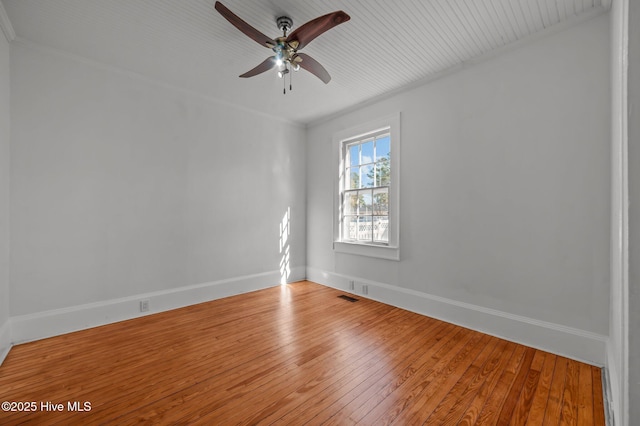 unfurnished room featuring ceiling fan, wood-type flooring, and ornamental molding