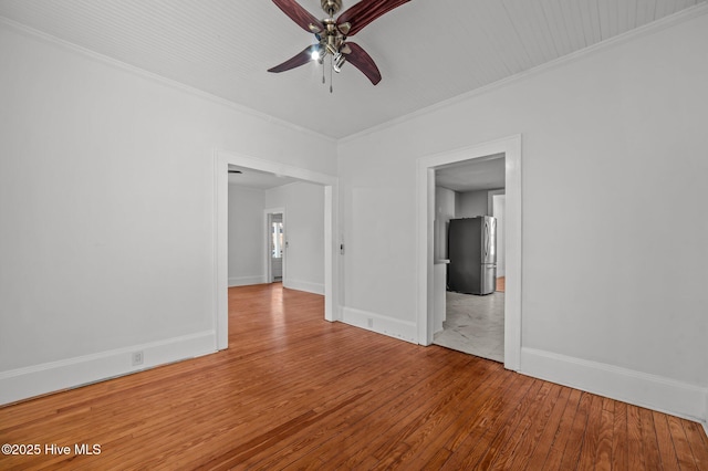 spare room with crown molding, hardwood / wood-style floors, and ceiling fan