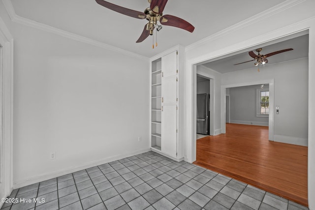 unfurnished room featuring ornamental molding, light tile patterned flooring, and ceiling fan