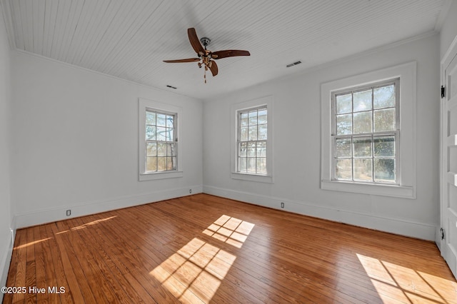 unfurnished room with ceiling fan, plenty of natural light, ornamental molding, and light wood-type flooring