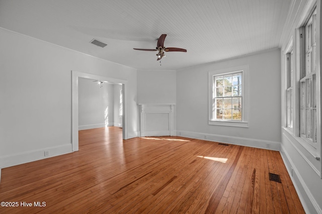 unfurnished living room featuring crown molding, ceiling fan, and light wood-type flooring