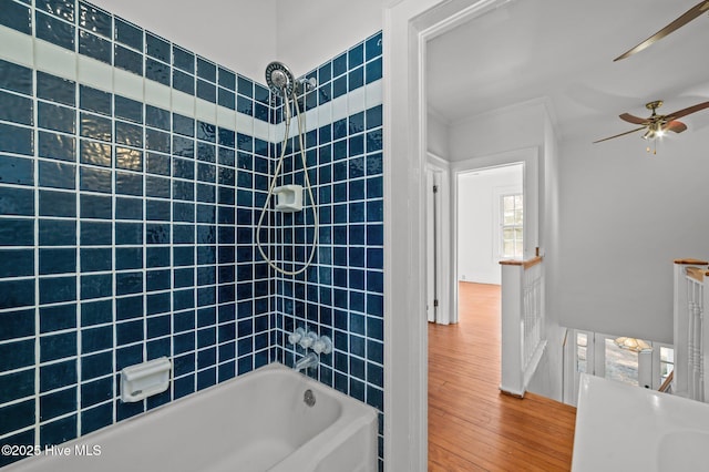 bathroom featuring crown molding, tiled shower / bath, and hardwood / wood-style floors