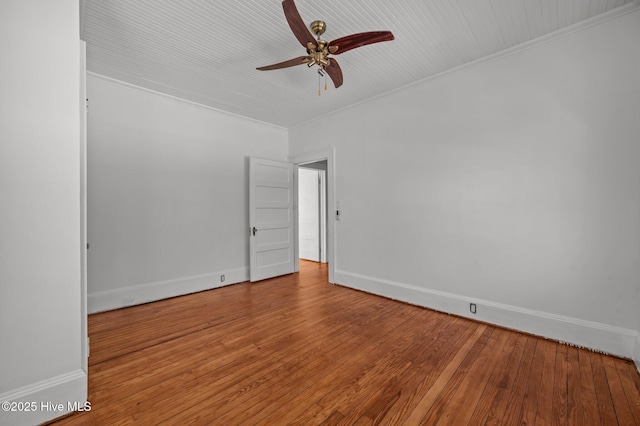 spare room featuring hardwood / wood-style flooring, ceiling fan, and crown molding