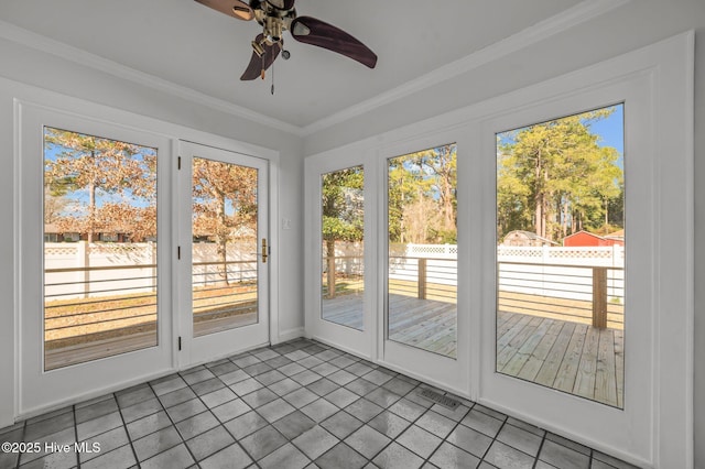 unfurnished sunroom featuring ceiling fan