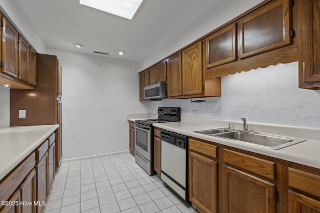 kitchen featuring sink, light tile patterned floors, and stainless steel appliances