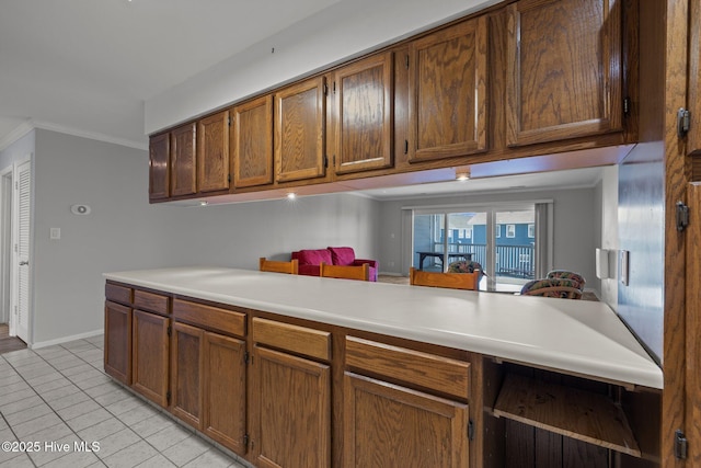 kitchen with crown molding and light tile patterned floors