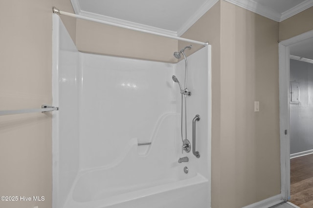 bathroom with ornamental molding, bathtub / shower combination, and wood-type flooring