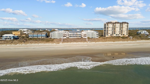 drone / aerial view with a water view and a beach view