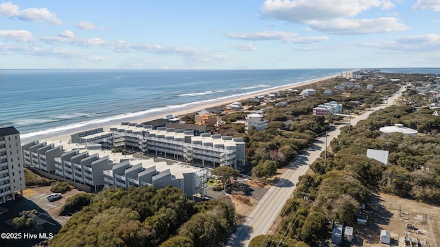 birds eye view of property featuring a water view and a beach view